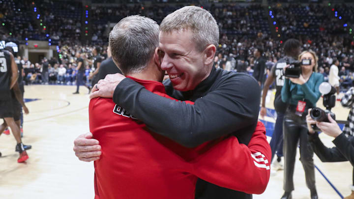 Feb 8, 2026; Morgantown, West Virginia, USA; West Virginia Mountaineers head coach Ross Hodge talks with Texas Tech Red Raiders head coach Grant McCasland before their game at Hope Coliseum. Mandatory Credit: Ben Queen-Imagn Images