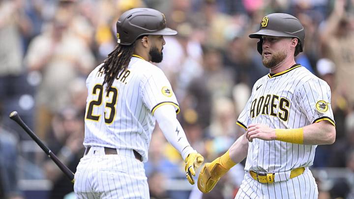 May 28, 2025; San Diego, California, USA; San Diego Padres second baseman Jake Cronenworth (9) is congratulated by Fernando Tatis Jr. (23) after scoring during the fourth inning against the Miami Marlins at Petco Park. Mandatory Credit: Denis Poroy-Imagn Images