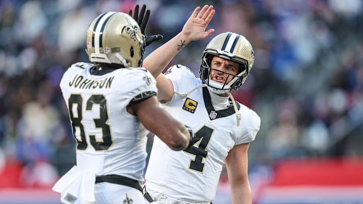 Dec 8, 2024; East Rutherford, New Jersey, USA; New Orleans Saints tight end Juwan Johnson (83) celebrates his touchdown reception from quarterback Derek Carr (4) during the second half against the New York Giants at MetLife Stadium. Mandatory Credit: Vincent Carchietta-Imagn Images