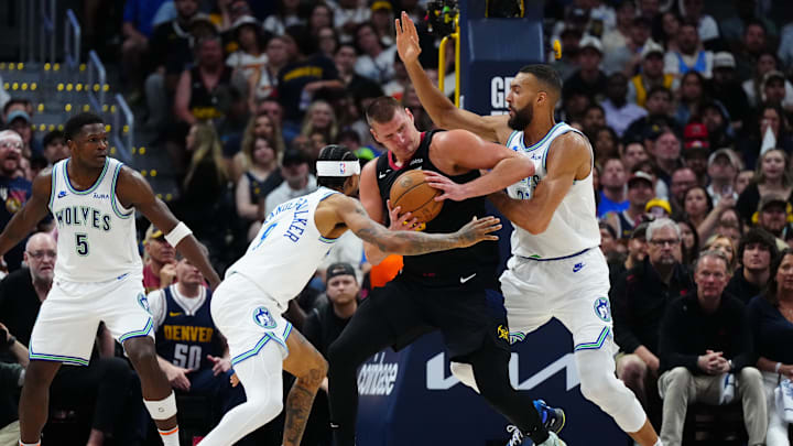 Minnesota Timberwolves center Rudy Gobert, right, and guard Nickeil Alexander-Walker, left, defend Denver Nuggets center Nikola Jokic in the first half in Game 7 of their second-round playoff series at Ball Arena in Denver on May 19, 2024.