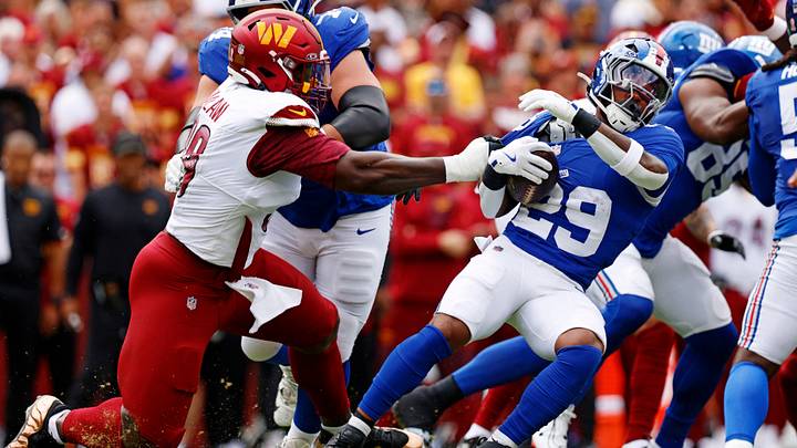 Sep 7, 2025; Landover, Maryland, USA; Washington Commanders defensive tackle Javon Kinlaw (99) tackles New York Giants running back Tyrone Tracy Jr. (29) during the first quarter at Northwest Stadium. Mandatory Credit: Peter Casey-Imagn Images