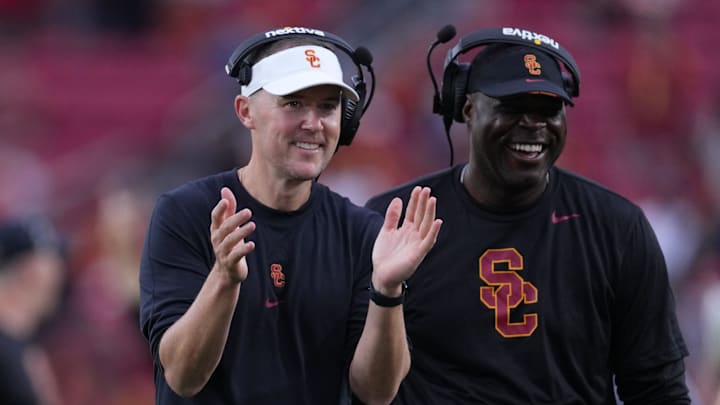 Sep 2, 2023; Los Angeles, California, USA; Southern California Trojans head coach Lincoln Riley (leff) and wide receivers coach Dennis Simmons react against the Nevada Wolf Pack in the second half at United Airlines Field at Los Angeles Memorial Coliseum.