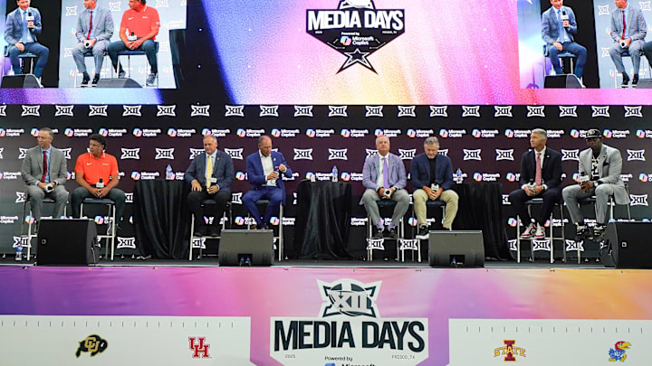 Head coaches Willie Fritz of Houston, Mike Gundy of Oklahoma State, Rich Rodriguez of West Virginia, Lance Leipold of Kansas, Sonny Dykes of TCU, Kyle Whittingham of Utah, Brent Brennan of Arizona and Deion Sanders of Colorado all sit on stage for a Coaches Roundtable during 2025 Big 12 Football Media Days at The Star.