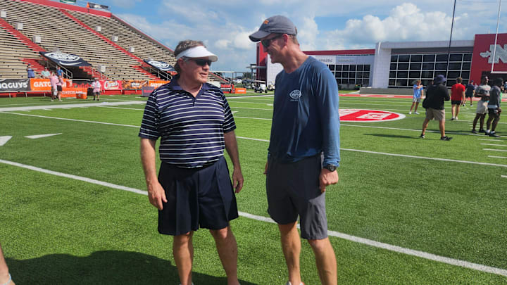 Legendary former NFL coach Bill Belichick talks with Peyton Manning at the 2024 Manning Passing Academy.