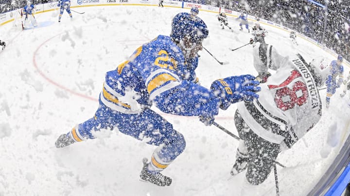 Oct 9, 2025; St. Louis, Missouri, USA; St. Louis Blues defenseman Logan Mailloux (23) skates against Minnesota Wild center Vinnie Hinostroza (18) after they sprayed ice in the air during the third period at Enterprise Center. Mandatory Credit: Jeff Curry-Imagn Images