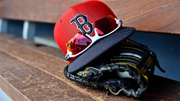 A detailed view of a Boston Red Sox cap, sunglasses and glove in the dugout  during a spring training game between the Washington Nationals and the Boston Red Sox at FITTEAM Ballpark of the Palm Beaches. 