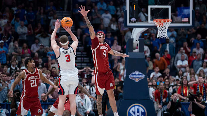 Mississippi Rebels guard Sean Pedulla (3) shoots over Arkansas Razorbacks forward Trevon Brazile (4) for the game-winning shot during their second round game of the SEC Men's Basketball Tournament at Bridgestone Arena in Nashville, Tenn., Thursday, March 13, 2025. The Rebels advanced to the third round with the 83-80 win.