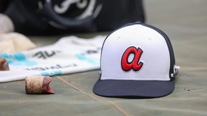 Apr 10, 2024; Atlanta, Georgia, USA; A detailed view of an Atlanta Braves hat on the field during batting practice at Truist Park. The game against the New York Mets was postponed due to impending weather. Mandatory Credit: Brett Davis-Imagn Images Apr 10, 2024; Atlanta, Georgia, USA; A detailed view of an Atlanta Braves hat on the field during batting practice at Truist Park. The game against the New York Mets was postponed due to impending weather. Mandatory Credit: Brett Davis-Imagn Images