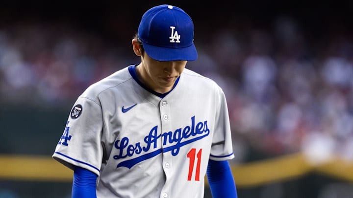 May 9, 2025; Phoenix, Arizona, USA; Los Angeles Dodgers pitcher Roki Sasaki (11) reacts against the Arizona Diamondbacks at Chase Field. Mandatory Credit: Mark J. Rebilas-Imagn Images