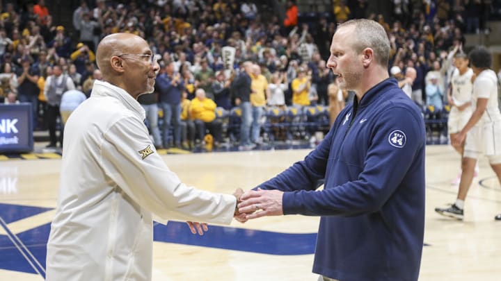 Mar 8, 2025; Morgantown, West Virginia, USA; West Virginia Mountaineers head coach Darian DeVries talks with UCF Knights head coach Johnny Dawkins after the game at WVU Coliseum. Mandatory Credit: Ben Queen-Imagn Images Mar 8, 2025; Morgantown, West Virginia, USA; West Virginia Mountaineers head coach Darian DeVries talks with UCF Knights head coach Johnny Dawkins after the game at WVU Coliseum. Mandatory Credit: Ben Queen-Imagn Images