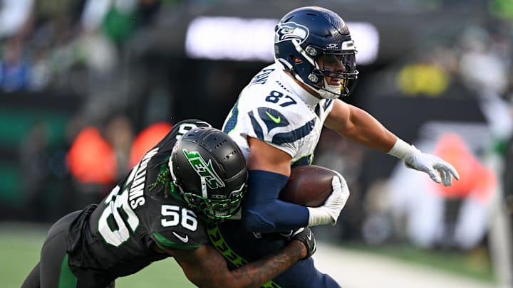 Dec 1, 2024; East Rutherford, New Jersey, USA; Seattle Seahawks tight end Noah Fant (87) runs with the ball during the third quarter and is tackled by New York Jets linebacker Quincy Williams (56) at MetLife Stadium. Mandatory Credit: Mark Smith-Imagn Images