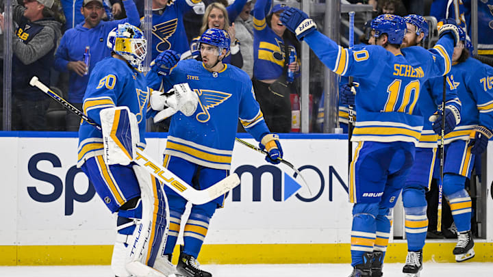 Mar 16, 2024; St. Louis, Missouri, USA;  St. Louis Blues center Jordan Kyrou (25) celebrates with goaltender Jordan Binnington (50) after the Blues defeated the Minnesota Wild in shoot outs at Enterprise Center. Mandatory Credit: Jeff Curry-Imagn Images