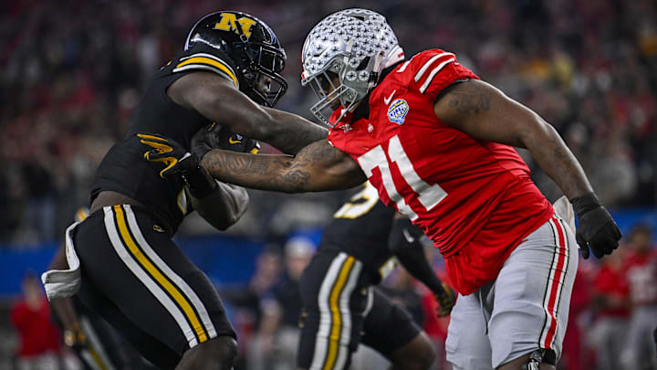 Ohio State's Josh Simmons blocks former Missouri defensive lineman Darius Robinson. Simmons is among the draft's top tackles.