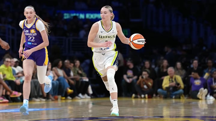 Aug 20, 2025; Los Angeles, California, USA; Dallas Wings guard Paige Bueckers (5) dribbles the ball against LA Sparks forward Cameron Brink (22) in the first half at Crypto.com Arena. Mandatory Credit: Kirby Lee-Imagn Images