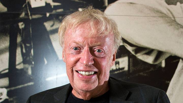 Phil Knight on the Nike Campus in Beaverton with a room sized image of Bill Bowerman in 2018. 