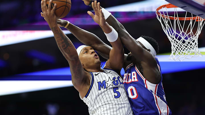 Oct 27, 2025; Philadelphia, Pennsylvania, USA; Orlando Magic forward Paolo Banchero (5) drives for a shot against Philadelphia 76ers center Adem Bona (30) during the first quarter at Xfinity Mobile Arena. Mandatory Credit: Bill Streicher-Imagn Images Oct 27, 2025; Philadelphia, Pennsylvania, USA; Orlando Magic forward Paolo Banchero (5) drives for a shot against Philadelphia 76ers center Adem Bona (30) during the first quarter at Xfinity Mobile Arena. Mandatory Credit: Bill Streicher-Imagn Images