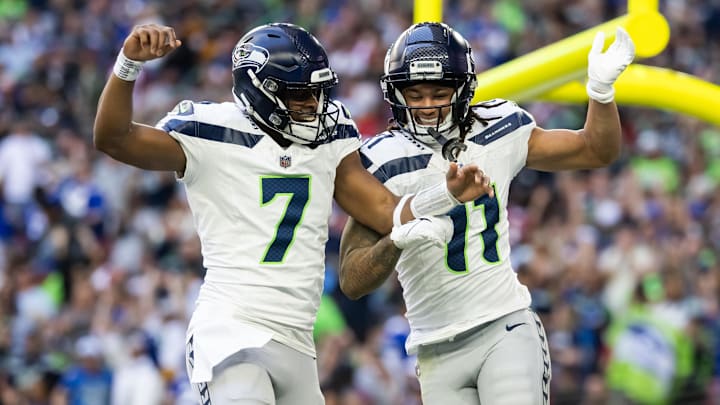 Dec 8, 2024; Glendale, Arizona, USA; Seattle Seahawks quarterback Geno Smith (7) celebrates a touchdown with wide receiver Jaxon Smith-Njigba (11) against the Arizona Cardinals in the first half at State Farm Stadium. Mandatory Credit: Mark J. Rebilas-Imagn Images