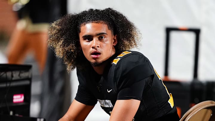Oct 20, 2023; Carrollton, GA, USA; Carrollton Trojans quarterback Julian Lewis (10) watches on from the sidelines against the Westlake Lions during the first half at Grisham Stadium. The 15-year-old Carrollton High student has already committed to playing for the University of Southern California Trojans and has been considered one of the top high school quarterback prospects. 