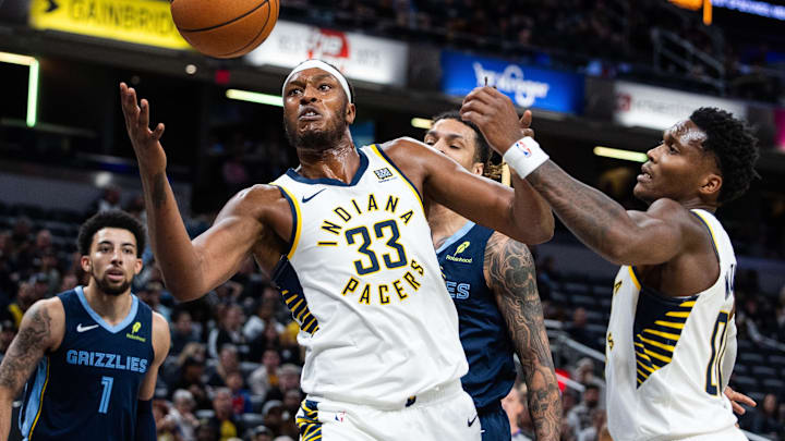 Oct 14, 2024; Indianapolis, Indiana, USA; Indiana Pacers center Myles Turner (33) rebounds the ball while Memphis Grizzlies forward Brandon Clarke (15) defends in the first quarter at Gainbridge Fieldhouse. Mandatory Credit: Trevor Ruszkowski-Imagn Images
