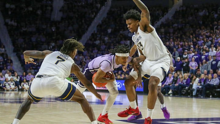 Jan 25, 2025; Manhattan, Kansas, USA; Kansas State Wildcats guard Dug McDaniel (0) drives to the basket between West Virginia Mountaineers forward Amani Hansberry (13) and guard Javon Small (7) during the first half at Bramlage Coliseum. Mandatory Credit: Scott Sewell-Imagn Images