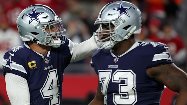 Dallas Cowboys quarterback Dak Prescott reacts with offensive tackle Tyler Smith before a game against the Tampa Bay Buccaneers.