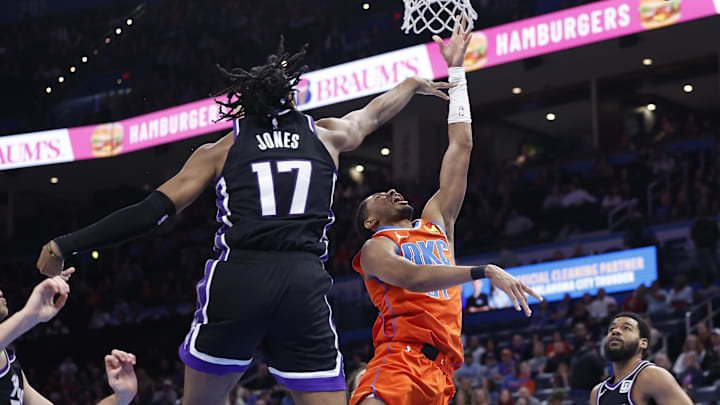 Feb 1, 2025; Oklahoma City, Oklahoma, USA; Oklahoma City Thunder guard Aaron Wiggins (21) goes up for a basket as Sacramento Kings center Isaac Jones (17) defends during the second half at Paycom Center. Mandatory Credit: Alonzo Adams-Imagn Images Feb 1, 2025; Oklahoma City, Oklahoma, USA; Oklahoma City Thunder guard Aaron Wiggins (21) goes up for a basket as Sacramento Kings center Isaac Jones (17) defends during the second half at Paycom Center. Mandatory Credit: Alonzo Adams-Imagn Images