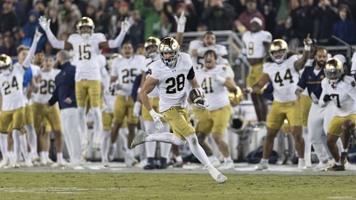Nov 29, 2025; Stanford, California, USA;   Notre Dame Fighting Irish safety Luke Talich (28) runs for a touchdown on a fake punt against the Stanford Cardinal during the second quarter at Stanford Stadium. Mandatory Credit: Stan Szeto-Imagn Images