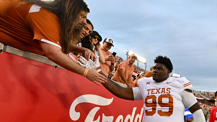 Oct 21, 2023; Houston, Texas, USA; Texas Longhorns defensive lineman Sydir Mitchell (99) high fives fans after the game against the Houston Cougars at TDECU Stadium. Mandatory Credit: Maria Lysaker-Imagn Images