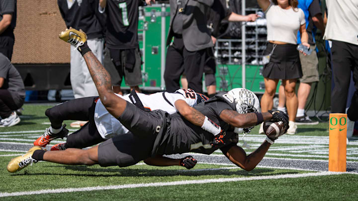 Oregon Ducks wide receiver Dakorien Moore dives in for a touchdown under coverage from Oregon State Beavers defensive back Jalil Tucker as the Oregon Ducks host the Oregon State Beavers Sept. 20, 2025, at Autzen Stadium in Eugene, Oregon.