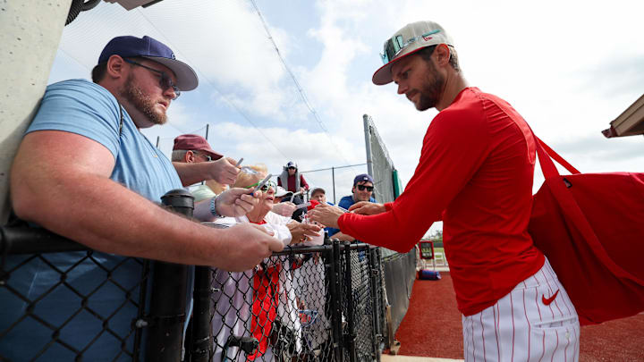 Philadelphia Phillies shortstop Trea Turner (7) signs autographs for fans during spring training workouts at BayCare Ballpark.