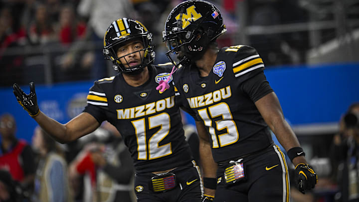 Dec 29, 2023; Arlington, TX, USA; Missouri Tigers defensive back Dreyden Norwood (12) and defensive back Daylan Carnell (13) celebrate a defensive stop against the Ohio State Buckeyes during the second quarter at AT&T Stadium. Mandatory Credit: Jerome Miron-Imagn Images