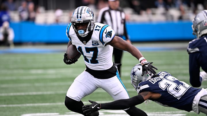 Dec 15, 2024; Charlotte, North Carolina, USA; Carolina Panthers wide receiver Xavier Legette (17) with the ball as Dallas Cowboys cornerback Amani Oruwariye (27) defefends in the first quarter at Bank of America Stadium. Mandatory Credit: Bob Donnan-Imagn Images
