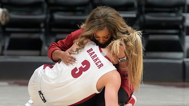 A member of the Alabama training staff comforts Alabama guard Sarah Ashlee Barker (3) after she was injured during the first half of the game with Florida at Coleman Coliseum Thursday, Jan. 2, 2025, in Tuscaloosa, Alabama.