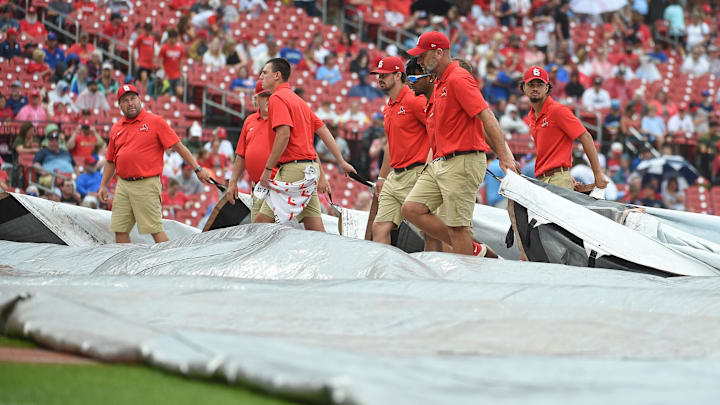 Sep 4, 2022; St. Louis, Missouri, USA; Grounds crew putting the tarp on the field during a rain delay prior to a game between the St. Louis Cardinals and the Chicago Cubs at Busch Stadium. Mandatory Credit: Joe Puetz-USA TODAY Sports