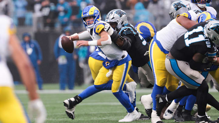 Nov 30, 2025; Charlotte, North Carolina, USA; Los Angeles Rams quarterback Matthew Stafford (9) is sacked by Carolina Panthers defensive end Derrick Brown (95) during the fourth quarter at Bank of America Stadium. Mandatory Credit: Scott Kinser-Imagn Images