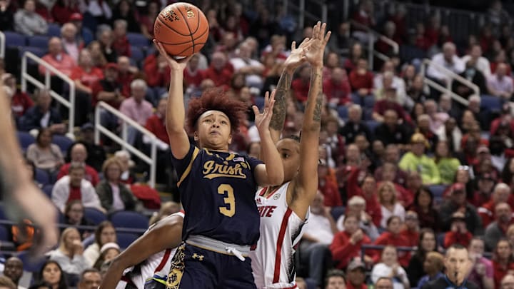 Mar 10, 2024; Greensboro, NC, USA; Notre Dame Fighting Irish guard Hannah Hidalgo (3) shoots the ball ahead of NC State Wolfpack guard Aziaha James (10) during the second half at Greensboro Coliseum. Mandatory Credit: David Yeazell-Imagn Images