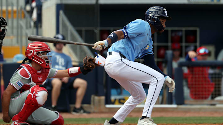 Feb 25, 2025; Port Charlotte, Florida, USA;  Tampa Bay Rays outfielder Chandler Simpson (96) singles against the Philadelphia Phillies during the third inning at Charlotte Sports Park. Mandatory Credit: Kim Klement Neitzel-Imagn Images