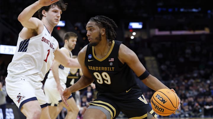 Mar 21, 2025; Cleveland, OH, USA; Vanderbilt Commodores forward Devin McGlockton (99) plays the ball defended by St. Mary's Gaels center Harry Wessels (1) in the second half at Rocket Arena. Mandatory Credit: Rick Osentoski-Imagn Images