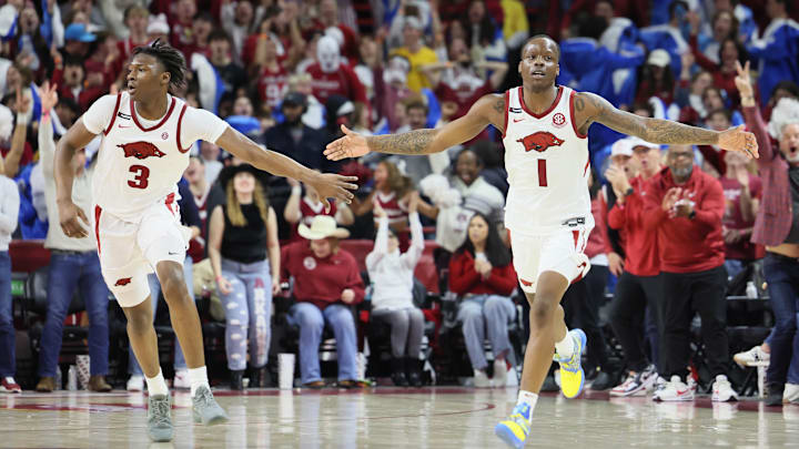 Feb 22, 2025; Fayetteville, Arkansas, USA; Arkansas Razorbacks forward Adou Thiero (3) and guard Johnell Davis (1) celebrate after a score against the Missouri Tigers during the second half at Bud Walton Arena. Mandatory Credit: Nelson Chenault-Imagn Images