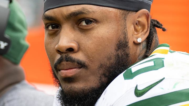 Green Bay Packers running back Josh Jacobs sitting on the sidelines. 