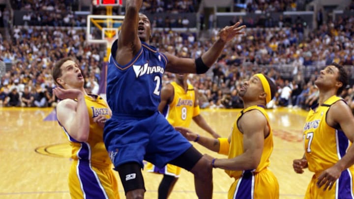 Mar 28, 2003; Los Angeles, CA, USA; FILE PHOTO;  Washington Wizards guard Michael Jordan (23) slices between Los Angeles Lakers forward Mark Madsen (35) and Derek Fisher (2) and Rick Fox (44) as he goes to the basket during the Wizards  108 - 94 loss to the Lakers at Staples Center. Jordan scored 23 points in the game.  Mandatory Credit: Robert Hanashiro-Imagn Images