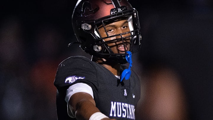 Lipscomb's Deuce Knight (2) directs his teammates against IMG at Lipscomb's Reese Smith Football