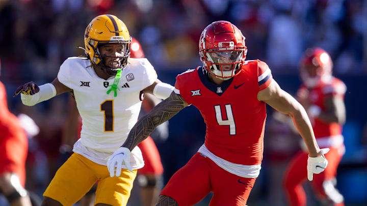 Nov 30, 2024; Tucson, Arizona, USA; Arizona Wildcats wide receiver Tetairoa McMillan (4) against Arizona State Sun Devils defensive back Keith Abney II (1) during the Territorial Cup at Arizona Stadium. Mandatory Credit: Mark J. Rebilas-Imagn Images Nov 30, 2024; Tucson, Arizona, USA; Arizona Wildcats wide receiver Tetairoa McMillan (4) against Arizona State Sun Devils defensive back Keith Abney II (1) during the Territorial Cup at Arizona Stadium. Mandatory Credit: Mark J. Rebilas-Imagn Images