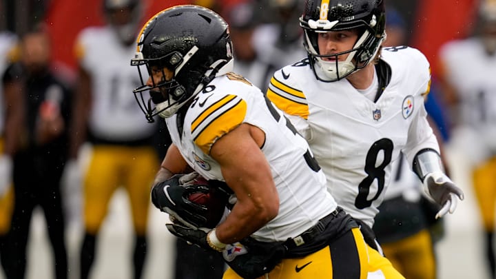 Pittsburgh Steelers quarterback Kenny Pickett (8) hands off to running back Jaylen Warren (30) in