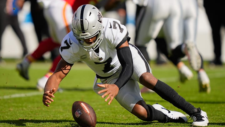 Oct 19, 2025; Kansas City, Missouri, USA; Las Vegas Raiders quarterback Geno Smith (7) recovers a fumble against the Kansas City Chiefs during the first quarter of the game at GEHA Field at Arrowhead Stadium. Mandatory Credit: Jay Biggerstaff-Imagn Images