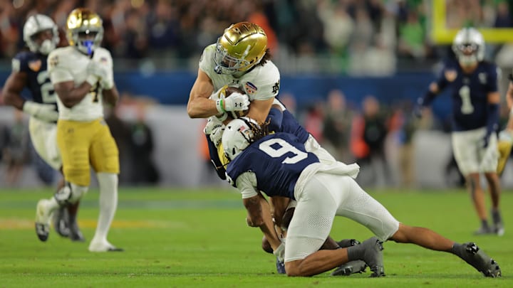 Jan 9, 2025; Miami, FL, USA;  Penn State Nittany Lions cornerback Elliot Washington II (9) tackles Notre Dame Fighting Irish wide receiver Jaden Greathouse (1) in the second half in the Orange Bowl at Hard Rock Stadium. 
