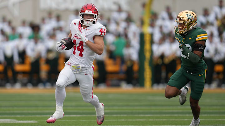 Nov 29, 2025; Waco, Texas, USA;  Houston Cougars running back Dean Connors (44) carries the ball ahead of Baylor Bears safety Cameren Jenkins (23) during the second half at McLane Stadium. 