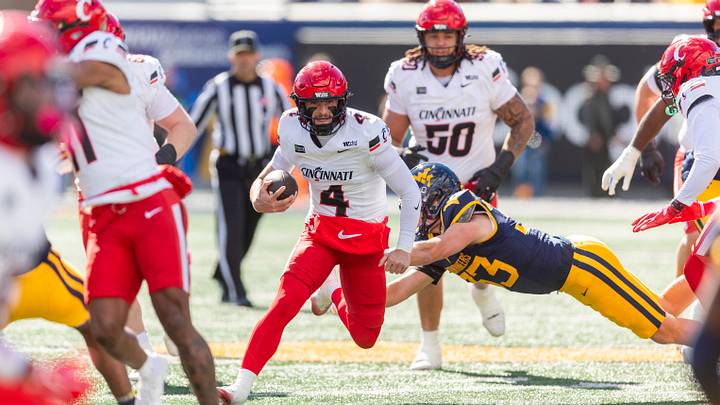 Oct 17, 2026; Morgantown, West Virginia, USA; Cincinnati Bearcats quarterback JC French IV (4) runs the ball during the first quarter against the West Virginia Mountaineers at Milan Puskar Stadium. Mandatory Credit: Ben Queen-Imagn Images Oct 17, 2026; Morgantown, West Virginia, USA; Cincinnati Bearcats quarterback JC French IV (4) runs the ball during the first quarter against the West Virginia Mountaineers at Milan Puskar Stadium. Mandatory Credit: Ben Queen-Imagn Images
