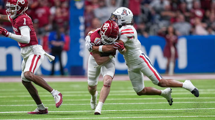 Dec 28, 2023; San Antonio, TX, USA;  Arizona Wildcats cornerback Treydan Stukes (2) brings down Oklahoma Sooners wide receiver Drake Stoops (12) in the first half at Alamodome. Mandatory Credit: Daniel Dunn-Imagn Images