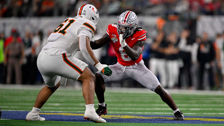 Dec 31, 2025; Arlington, TX, USA; Miami Hurricanes offensive lineman Francis Mauigoa (61) blocks Ohio State Buckeyes linebacker Arvell Reese (8) during the 2025 Cotton Bowl and quarterfinal game of the College Football Playoff at AT&T Stadium. Mandatory Credit: Jerome Miron-Imagn Images